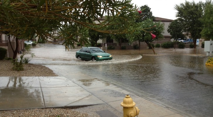 PHOENIX US - SEPTEMBER 9, 2013: Car slowly driving through flood