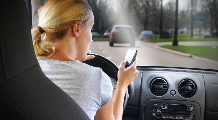 Woman Texting On Phone And Driving Car