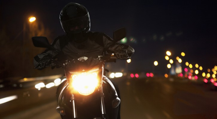 Young Man riding motorcycle at night