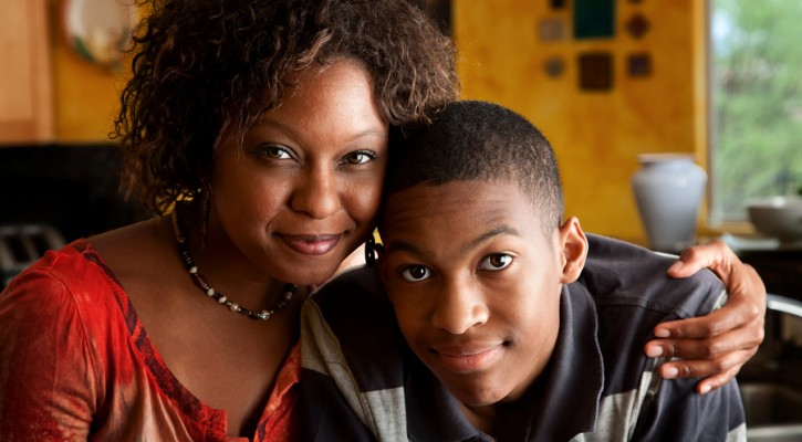 African-american Woman With Young Man In Kitchen