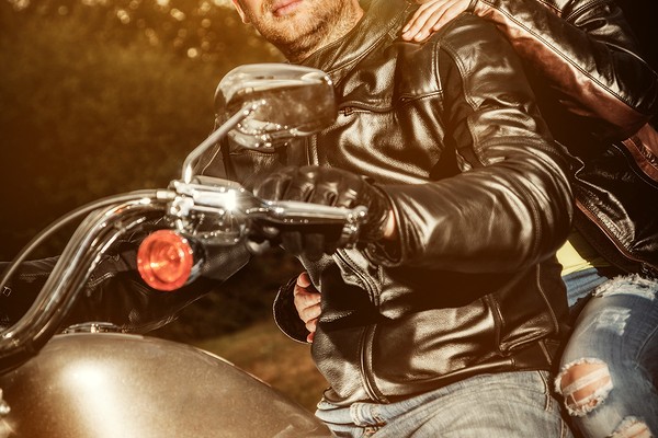 Biker couple, man and woman in leather jacket on a motorcycle.